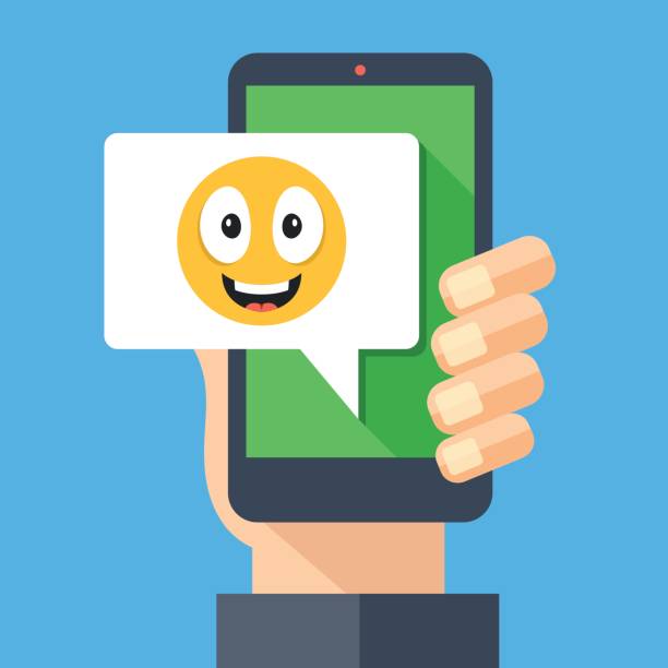 istock Hand holding smartphone with happy emoji message on screen. Happy emoticon icon. Social networking, IM, SMS, instant messaging on mobile device, online chat concepts. Modern flat design vector illustration 669306952