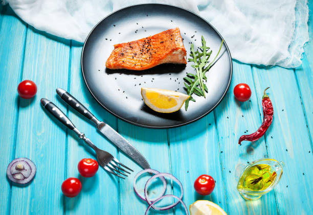 istock One piece of baked salmon with lemon 669315624
