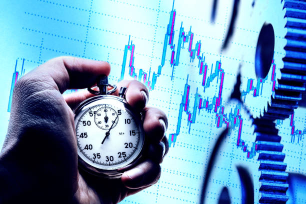 Male hand holding stopwatch on chart of stock market investment trading