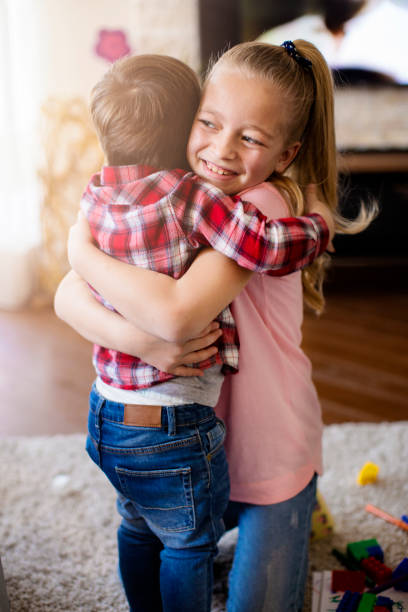 istock Little brother and sister hugging each other 669320108