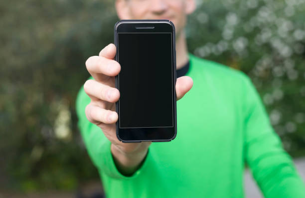 istock Man hand holding contemporary modern smartphone 669323722