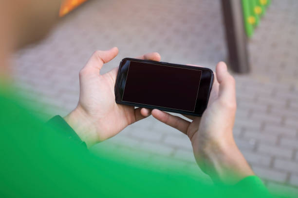 istock Man hand holding contemporary modern smartphone 669323764