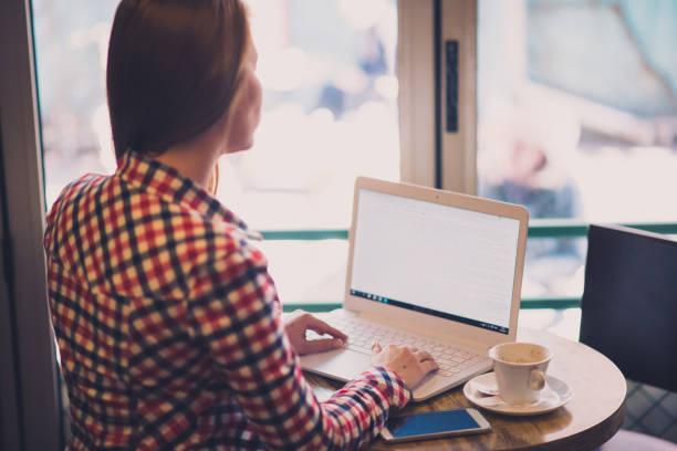 istock Woman sitting in cafe, drinking coffee and calling someone on phone 669326082