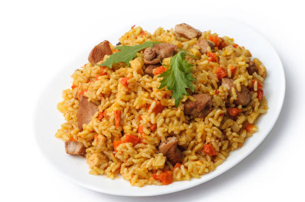 istock rice pilaf with meat and vegetables top view on a plate. Isolated on white. 669338742