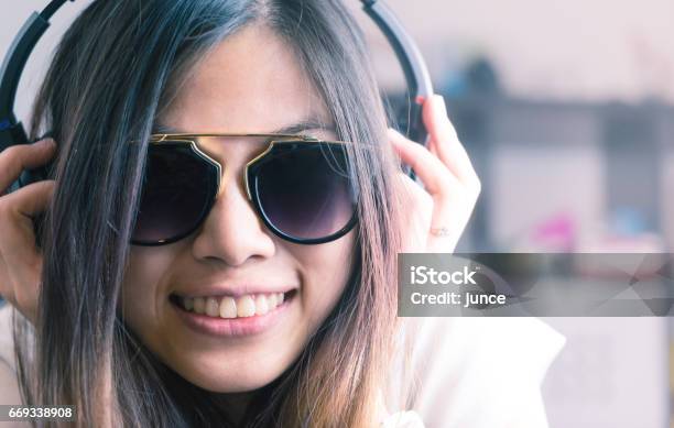 Cute Asian Girl Is Listening To Pop Dance Music On Headphone Stock Photo - Download Image Now