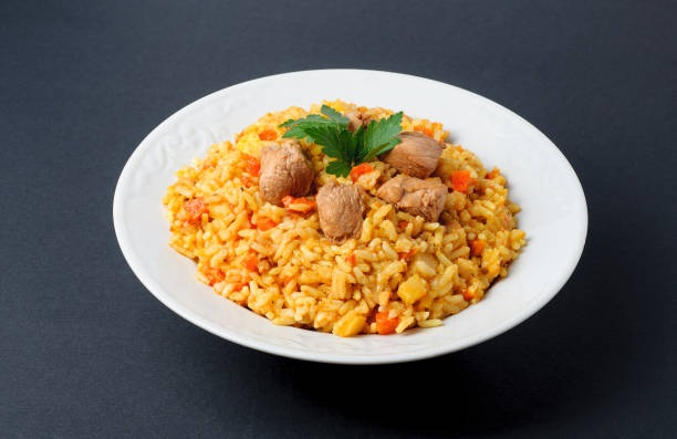 istock Pilaf in white plate isolated on gray background 669339378