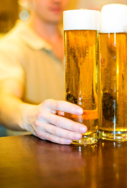 istock beer into a glass at the bar 669342524