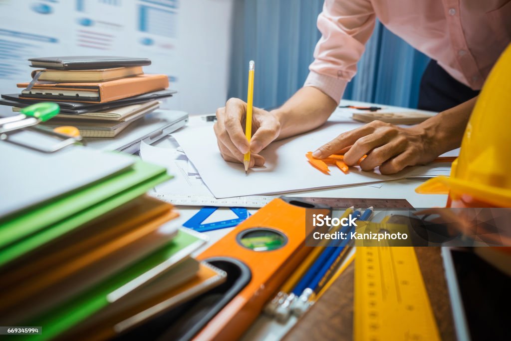 Business engineer contractor working at his desk table in office. Business Stock Photo