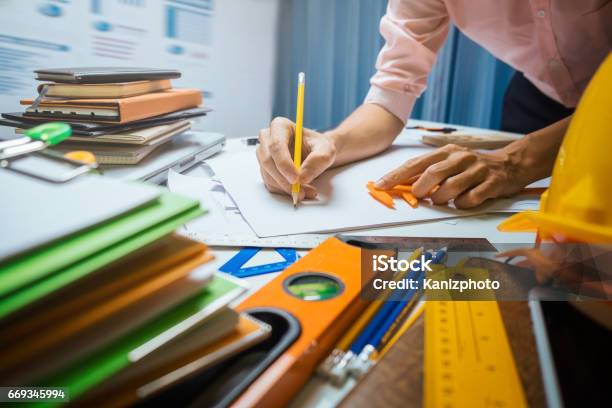 Business Engineer Contractor Working At His Desk Table In Office Stock Photo - Download Image Now