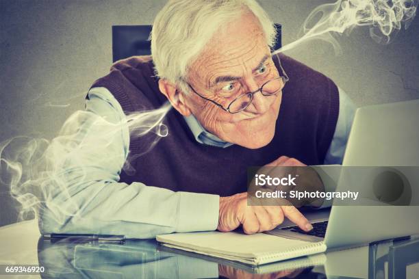 Stressed Elderly Old Man Using Computer Blowing Steam From Ears Stock Photo - Download Image Now