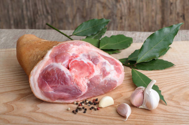 Raw pork knuckle with pepper. garlic and bay leaves Raw pork knuckle with pepper. garlic and bay leaves smoked pork stock pictures, royalty-free photos & images