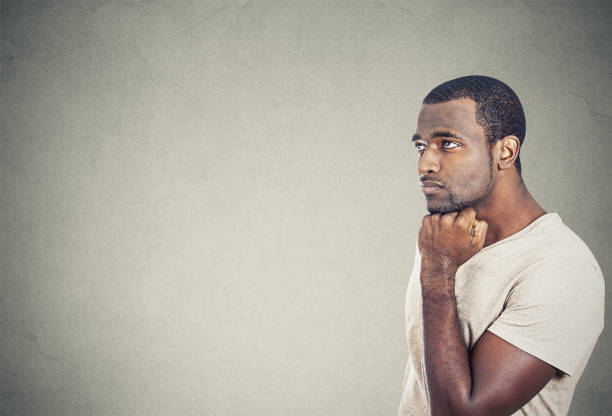 istock sad, depressed, worried young man looking up 669349416