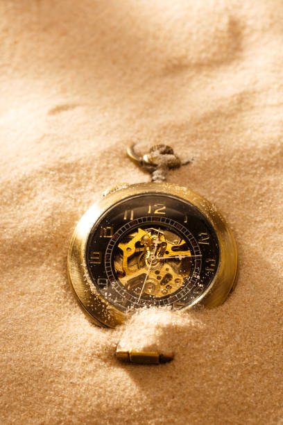 istock Pocket watch in beach sand 669352422