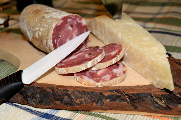 cutting board with cheese and salami sliced