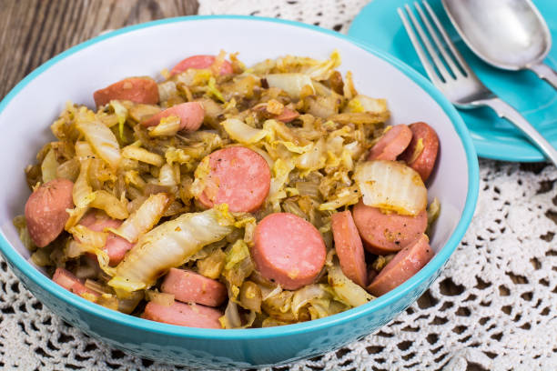 istock Sliced pork sausages with cabbage in ceramic bowl 669356396