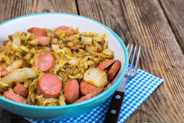 istock Sliced pork sausages with cabbage in ceramic bowl 669356536