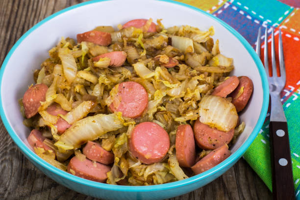 istock Sliced pork sausages with cabbage in ceramic bowl 669356564