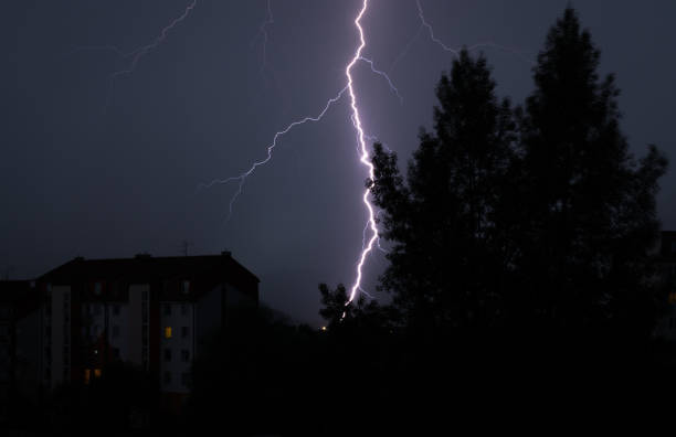 istock Lightning behind the houses and the tree. Slovakia 669360160