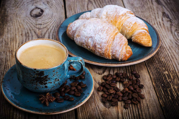 istock Coffee espresso and fresh croissant on wooden background 669360664