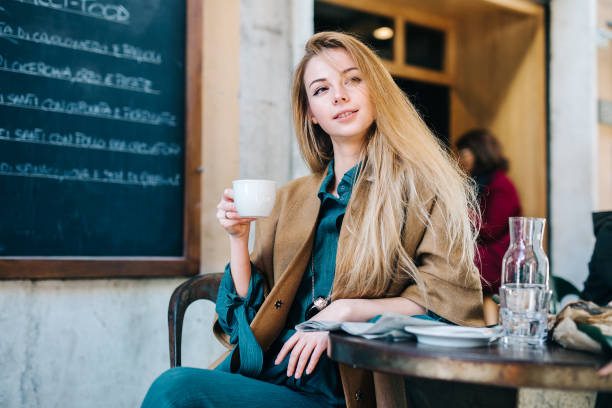 istock Cafe table young woman drinking coffee cup background lifestule 669366838