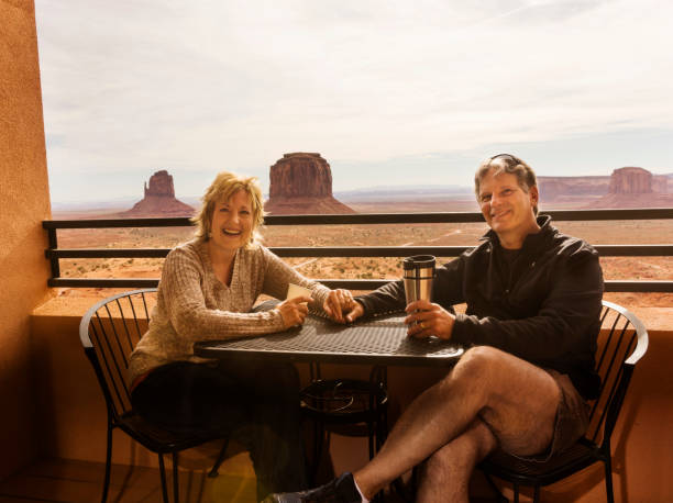 happy couple in 50s enjoy a room with a view - mitchell butte imagens e fotografias de stock