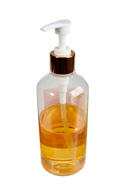 istock Spray bottle with mango massage oil isolated on white background 669367610