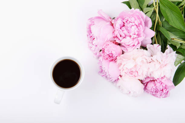 istock Black coffee with a beautiful bouquet of pink peonies 669367708