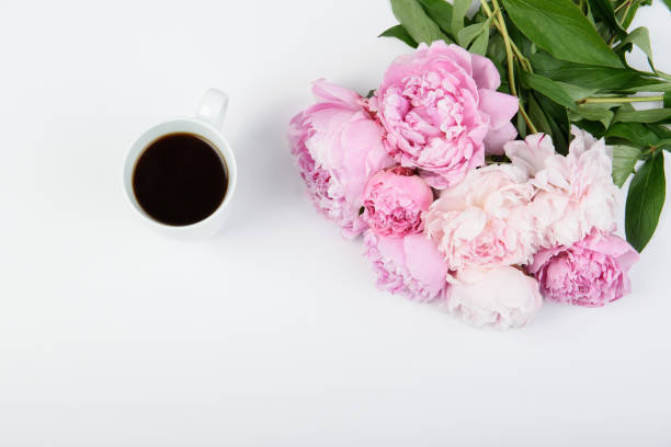 istock Black coffee with a beautiful bouquet of pink peonies 669367724