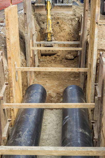 istock excavator digging trench for the ground piping 2 669380238
