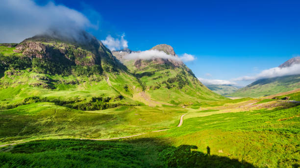 istock Beautiful sunrise and small man on cliff, Glencoe, Scotland 669380302