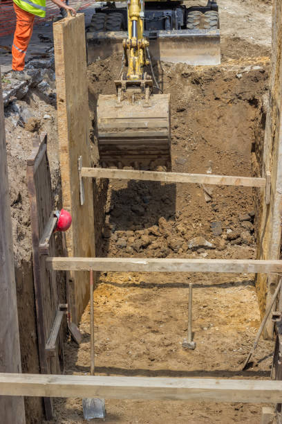 istock excavator digging trench for the ground piping 669380498