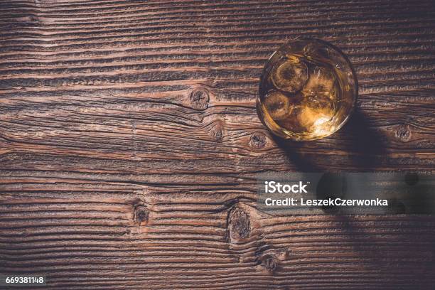 Overhead Shot Of Whiskey Glass With Ice Cubes Stock Photo - Download Image Now - Whiskey, Table, Brandy