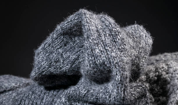 istock crumpled gray handmade cashmere wool fabric texture on a black background. 669384068