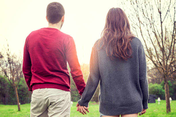 istock nice couple boyfriends relaxes walking hand in hand 669387374