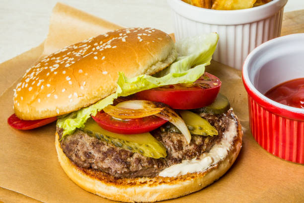 istock Burger with tomato, cucumber, lettuce and grilled onions. 669389614