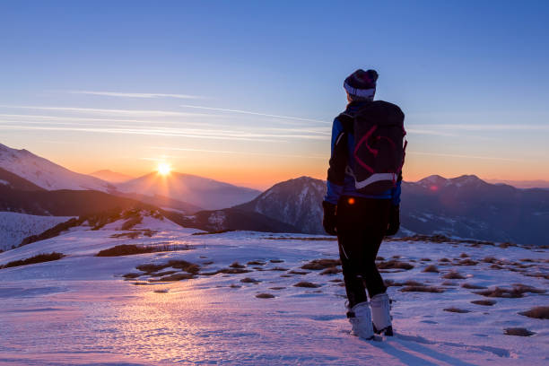 istock Woman skier looking at the sunset 669389984