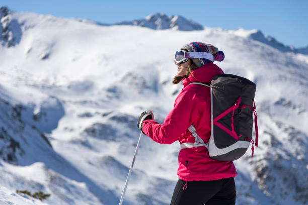 Woman skier taking a break on a sunny winter day stock photo