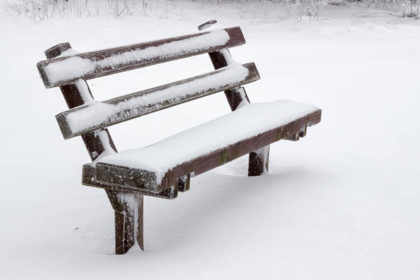 istock snow covered wooden sitting bench 669393036