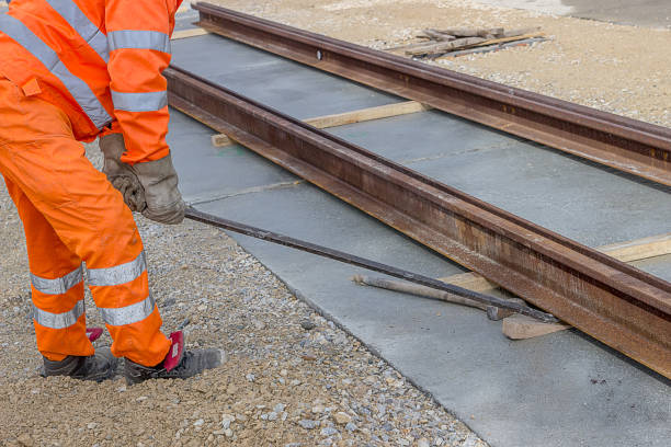 istock Align piece of railroad track before welding 669394128