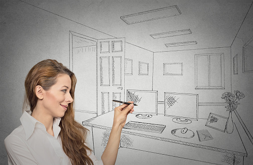 Portrait woman designer drawing with pen, pencil future apartment, architecture, home renovation, remodeling concept isolated on grey wall background. Positive human face expressions