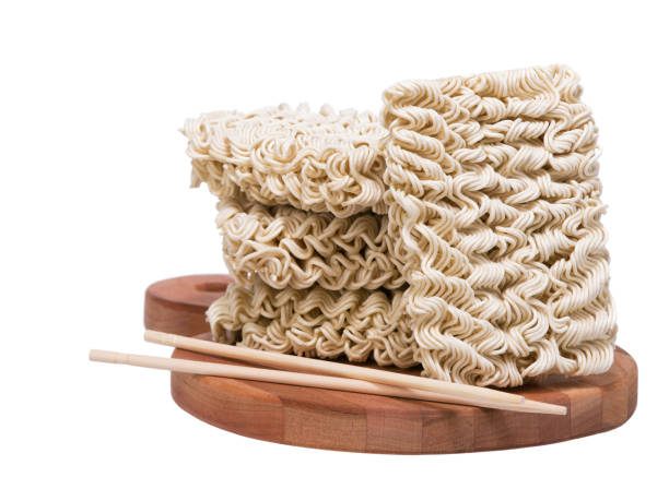 istock Ramen instant raw noodles on wooden plank 3/4 with chopsticks 669402976