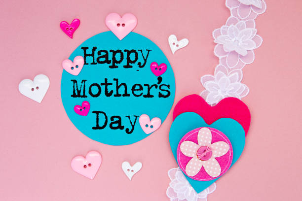 Sewing -  Happy Mother's Day with lace and buttons on pink background