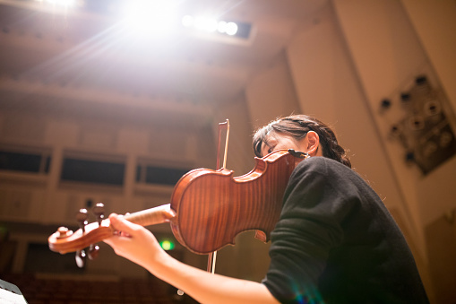 Woman playing violin on concert