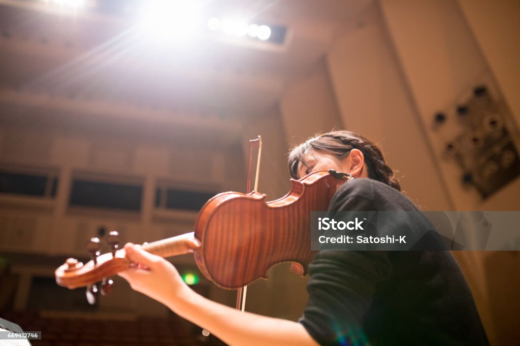 Woman playing violin Woman playing violin on concert Violin Stock Photo