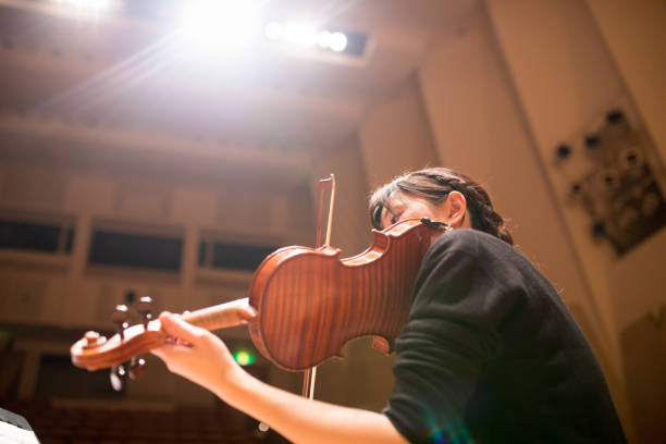 Woman playing violin Woman playing violin on concert string instrument stock pictures, royalty-free photos & images