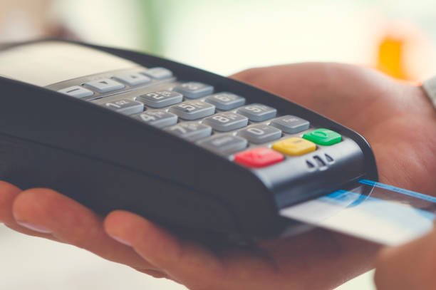 istock Woman placing credit card into reader. 669414146