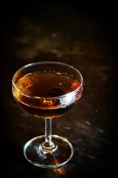 Photo of manhattan classic whisky cocktail drink in modern bar