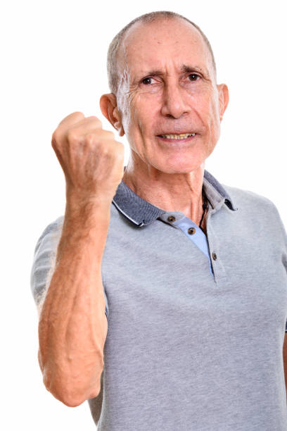 istock Studio shot of angry senior man with arm raised 669434376