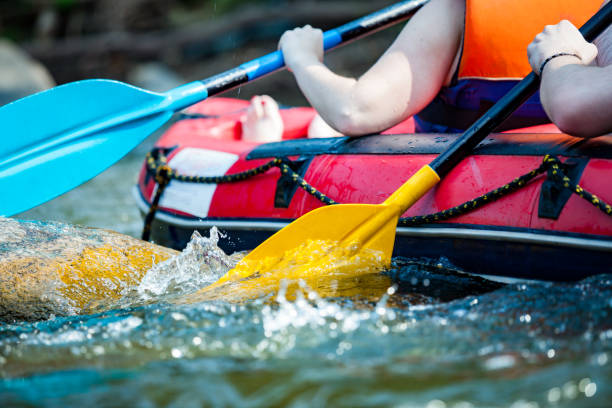 close-up hand of young person is rafting on the river, extreme and fun sport at tourist attraction - rafting imagens e fotografias de stock