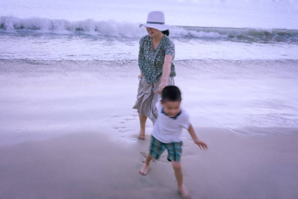 Mother and son playing at beach
